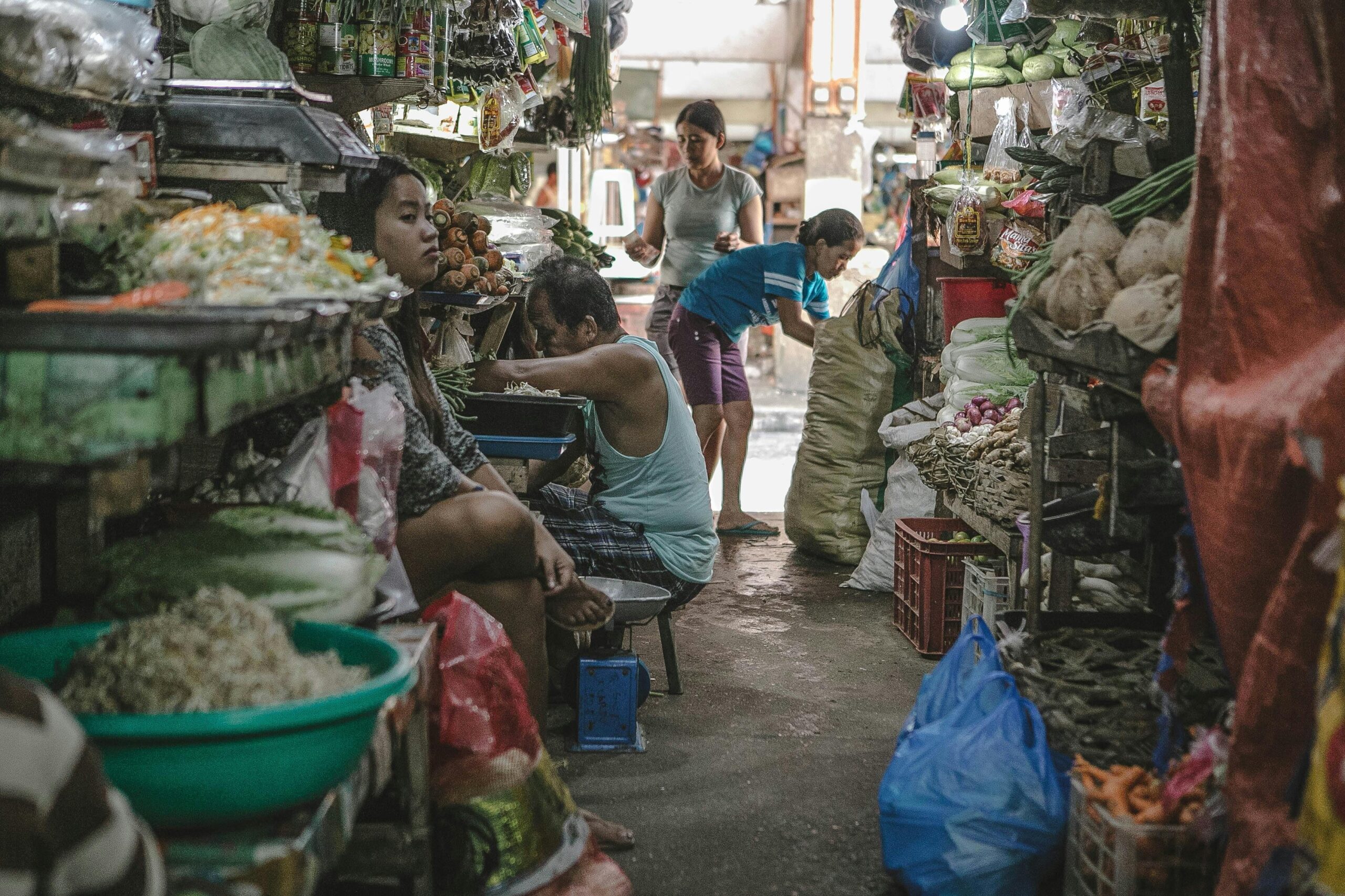 A colorful shopping cart filled with fresh produce and packaged goods
