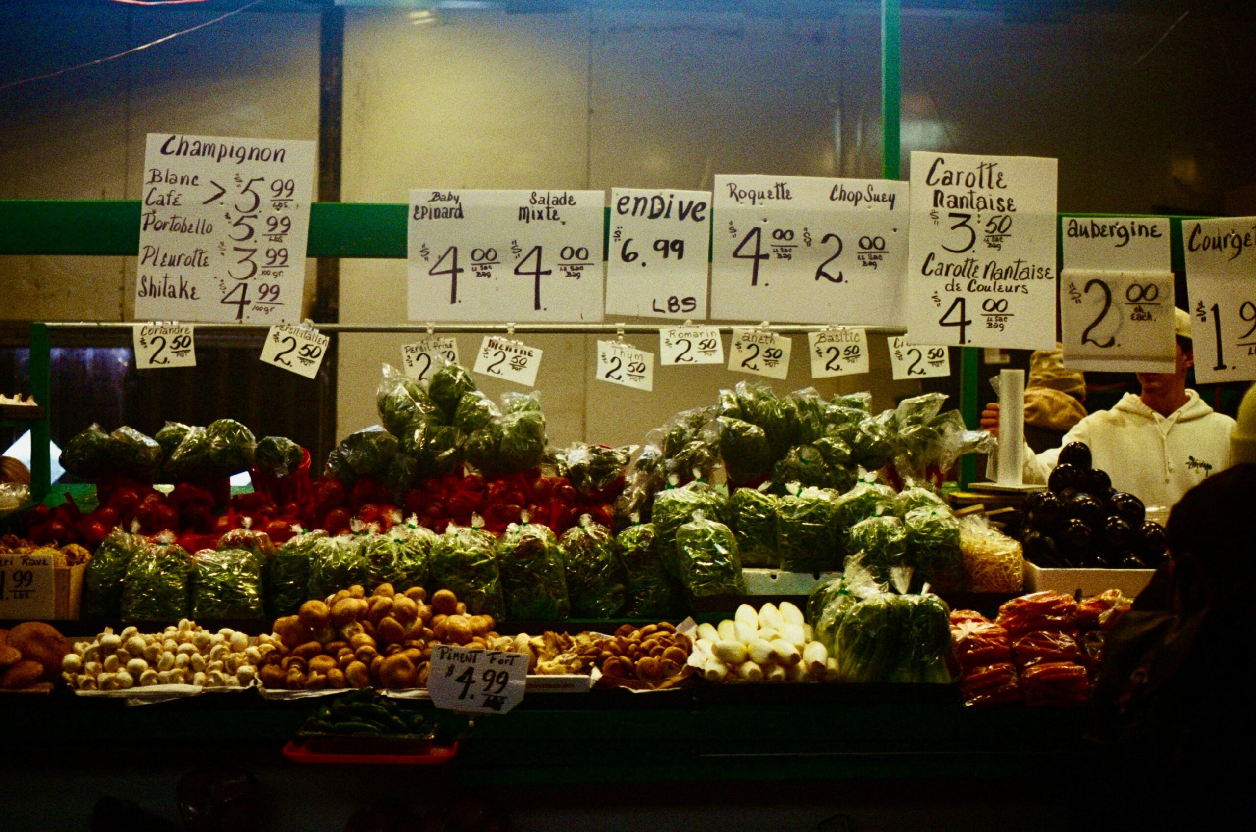 A neatly written shopping list placed next to fresh produce