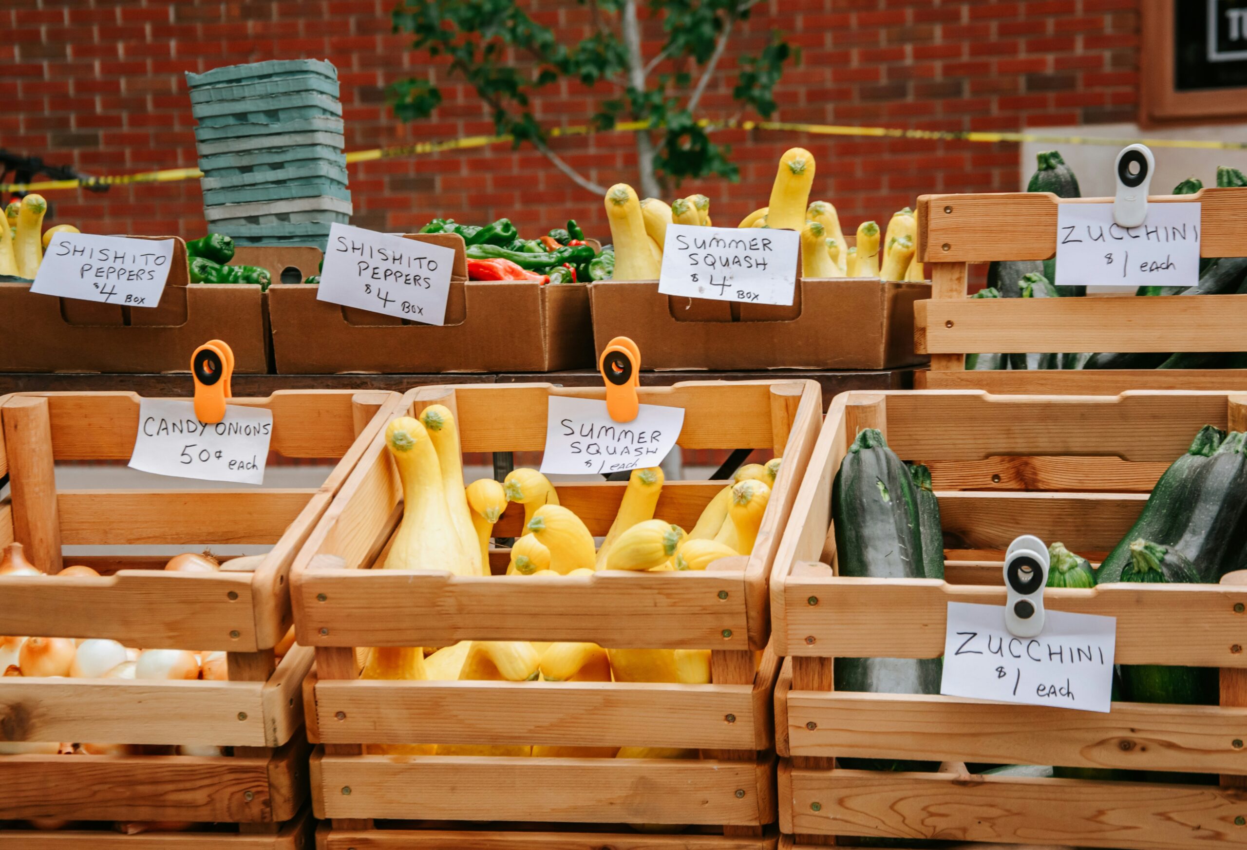A basket filled with fresh produce like spinach, carrots, and apples priced affordably