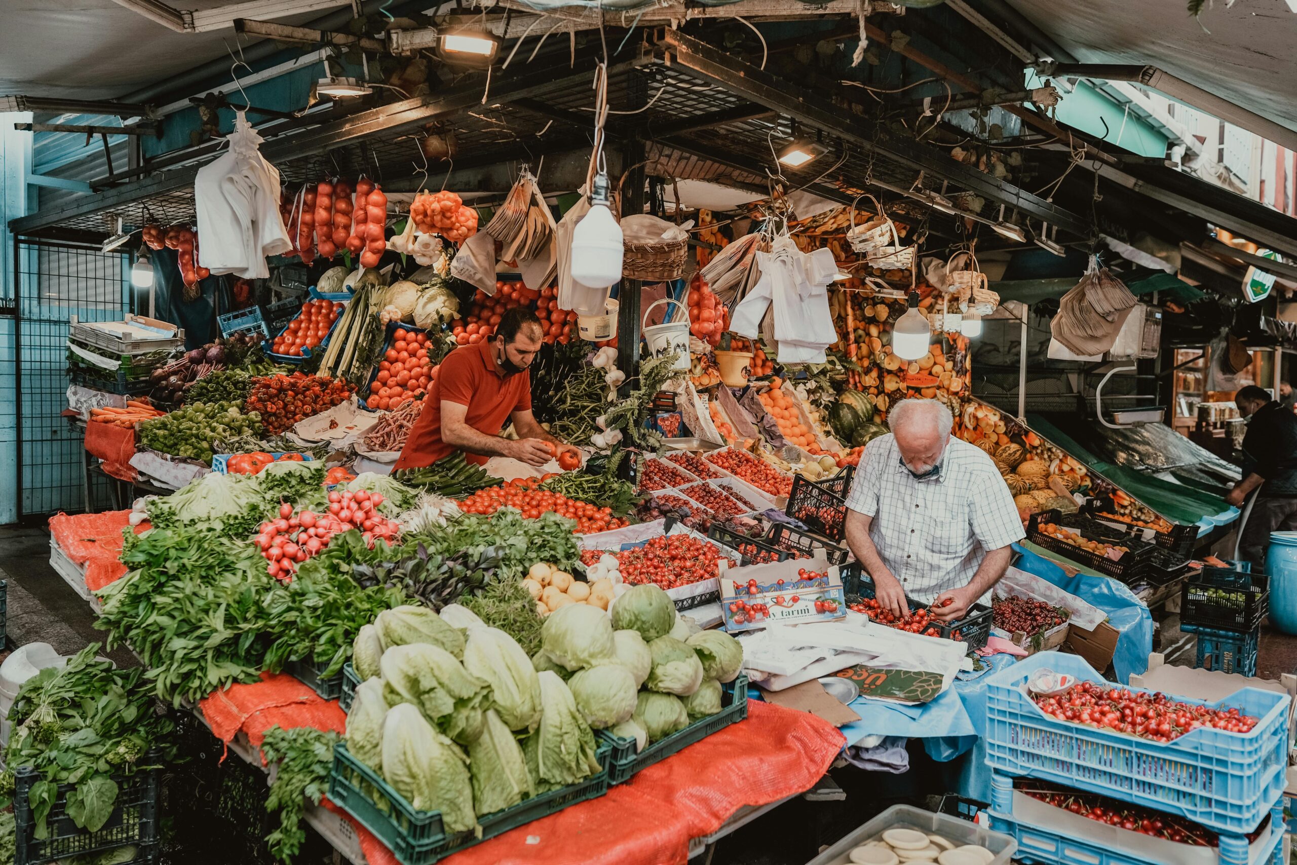 Colorful fresh fruits and vegetables being sold at a bustling market
