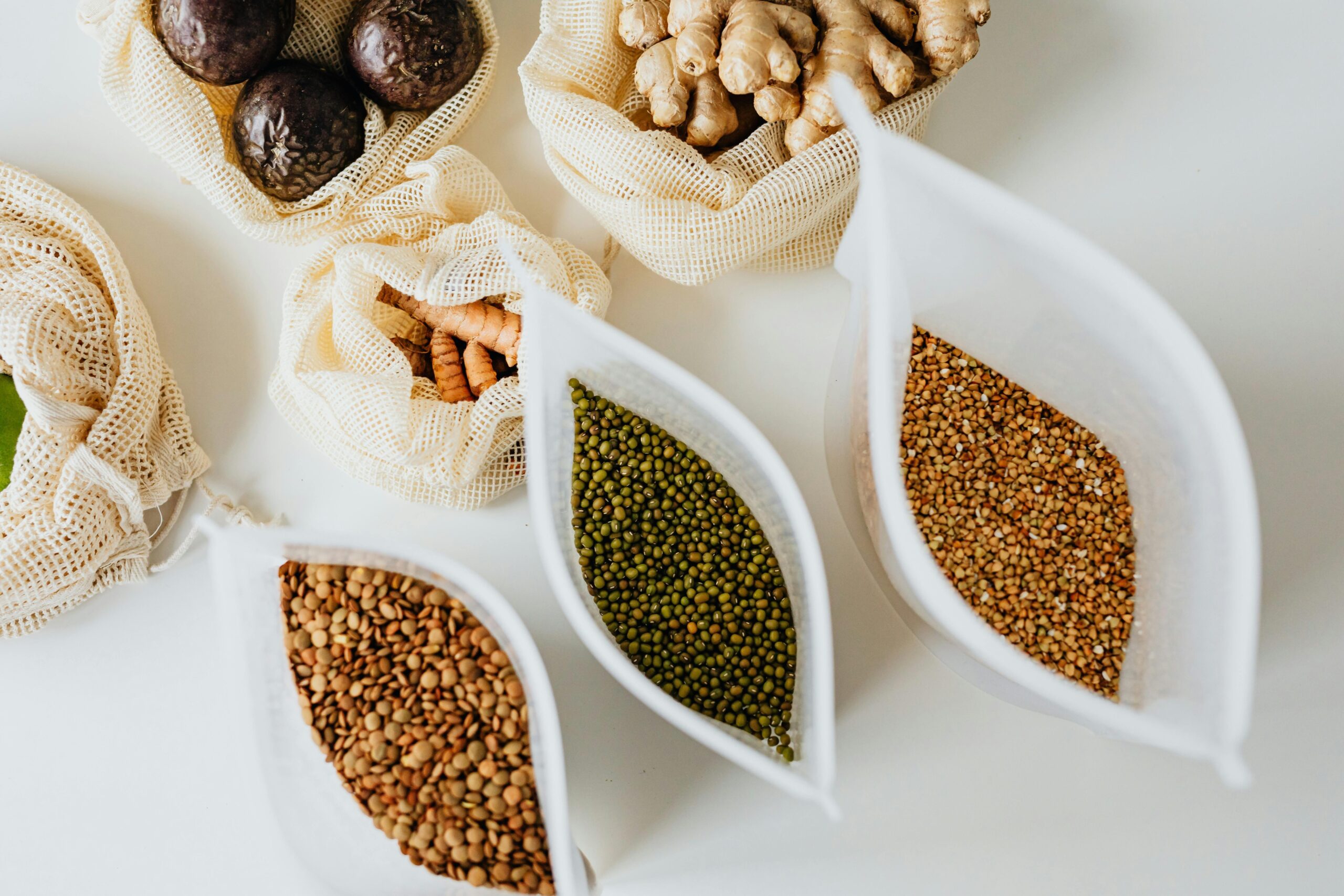 Healthy grocery items like fruits, vegetables, and grains neatly arranged on a table