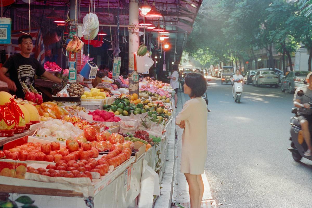 A happy family holding reusable bags filled with groceries after saving big time.