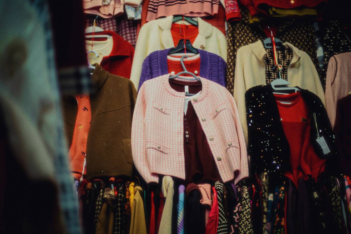 A shopping cart filled with fresh produce and pantry staples