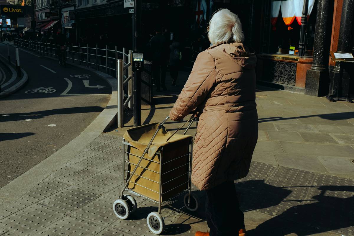 Happy shopper pushing cart full of fresh produce