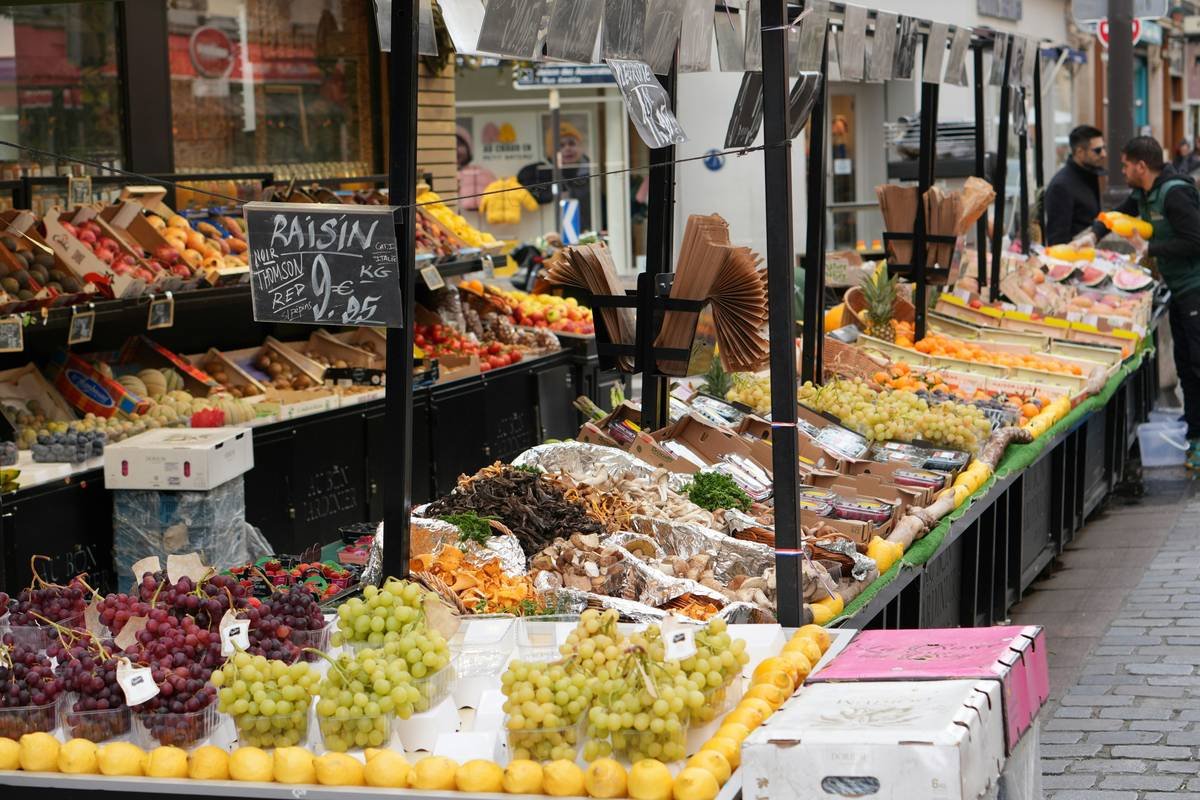 A shopper reviewing weekly specials at Tops Market