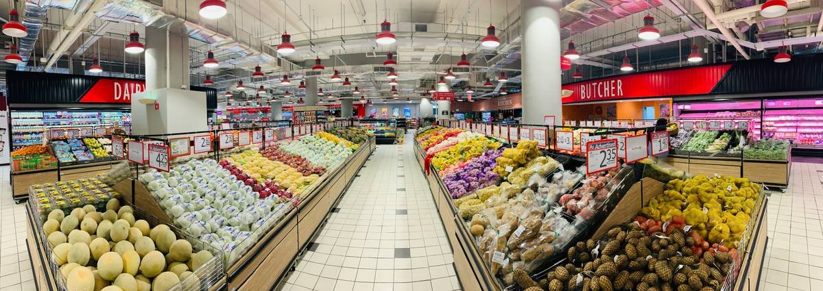 A photo showcasing a grocery cart filled with discounted organic vegetables and health snacks.
