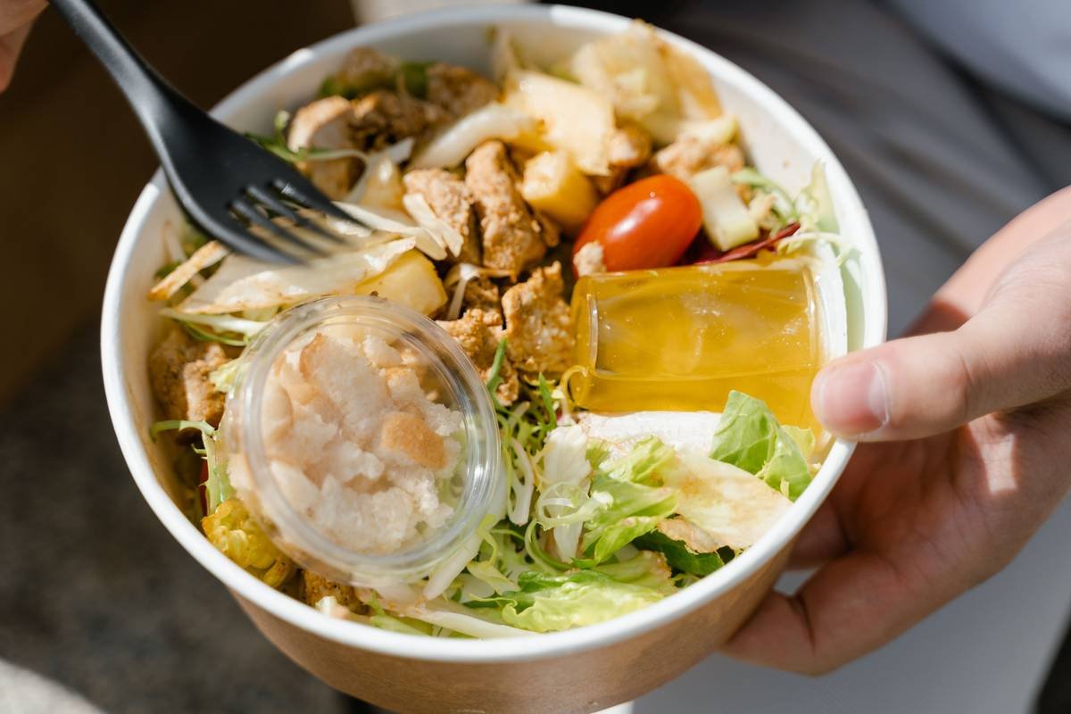 Infographic showing Tops Friendly Markets carry out menu categories: Hot Bar ($5.99–$8.99), Fresh Salads ($4.99–$7.99), Sushi ($6.99–$9.99), Sandwiches ($5.49–$7.49), Bakery ($2.99–$4.99)
