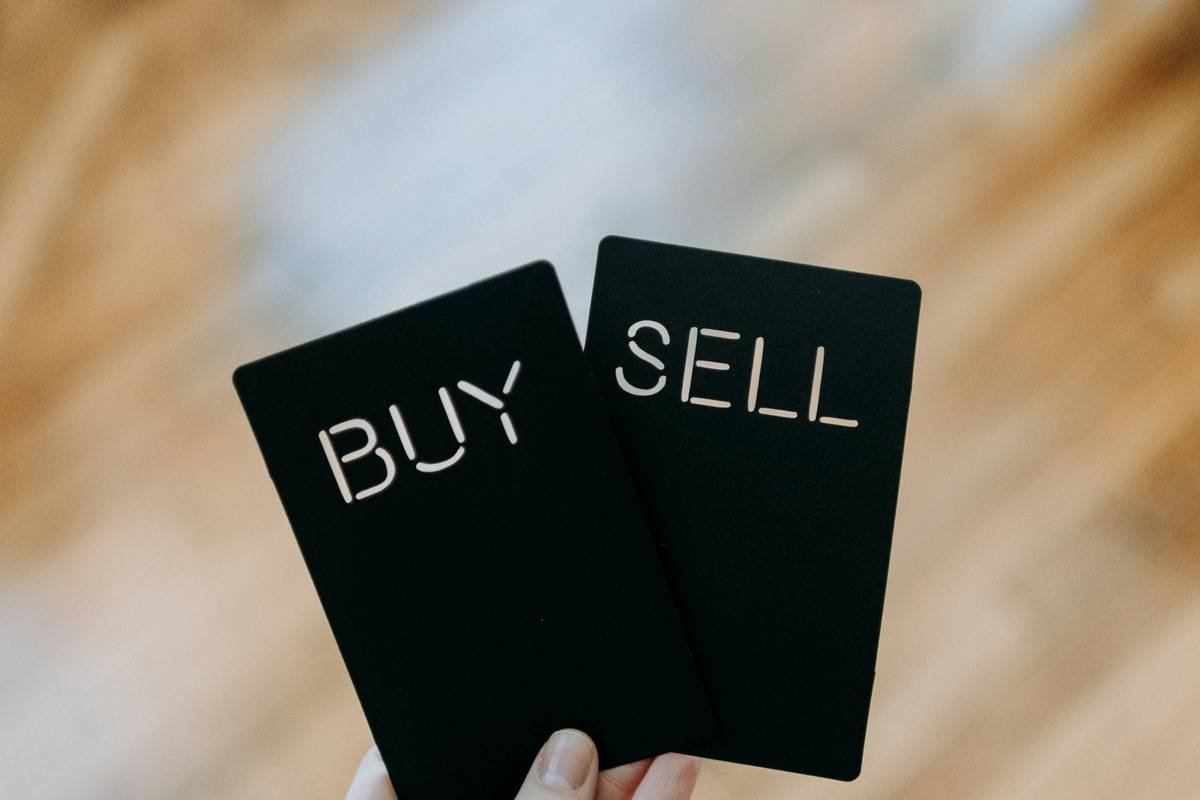 Woman comparing prices at Tops Friendly Markets during a bear market sale event