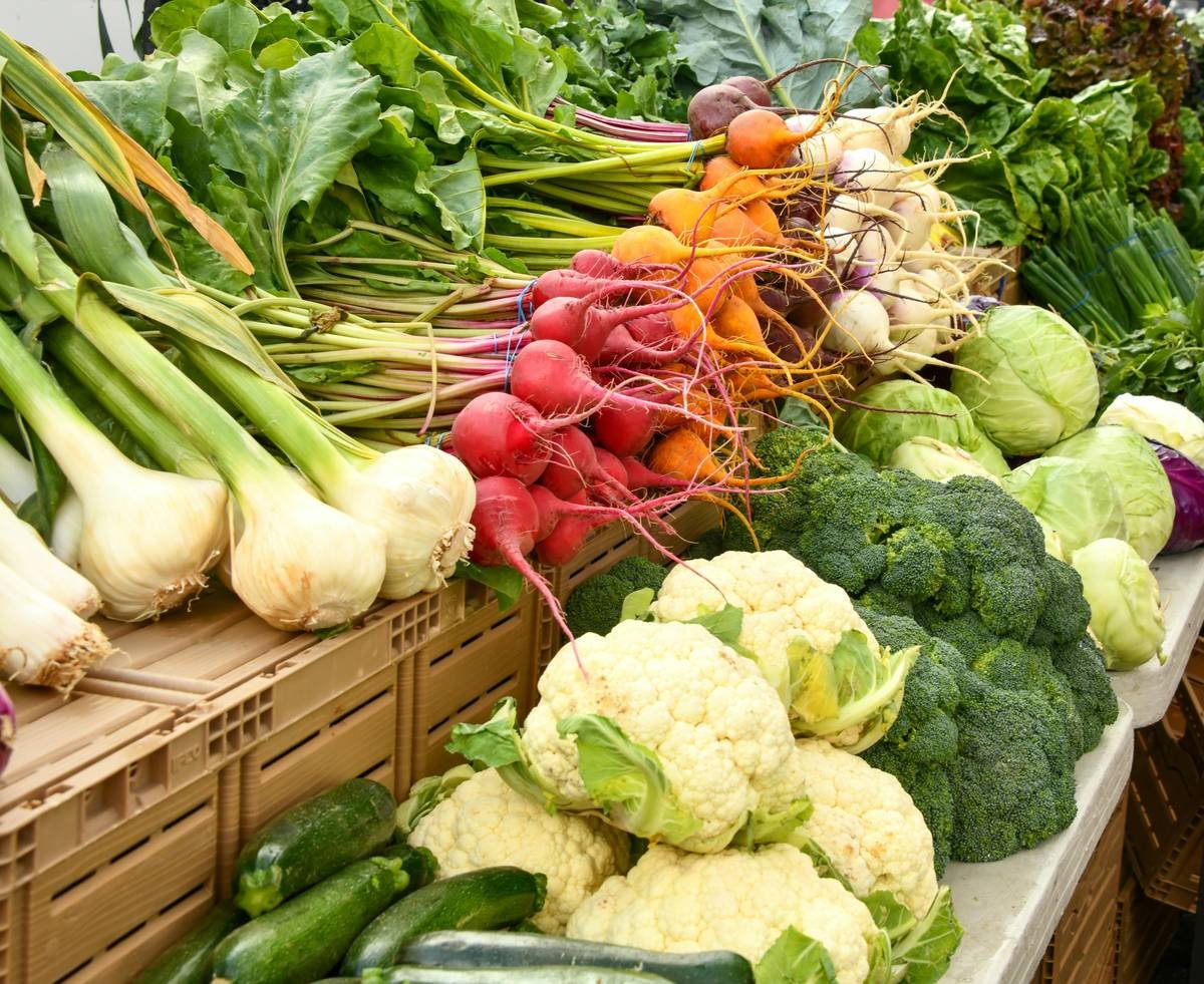 smart buy focused friendly market pick featuring fresh produce and store-brand pantry staples in a Tops cart