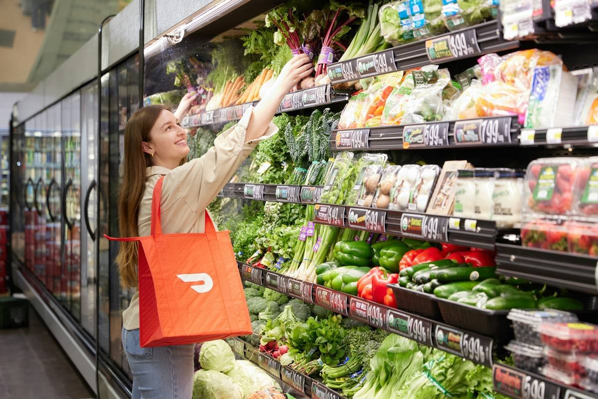 weekly steal focused friendly market how: shopper comparing unit prices on fresh produce at Tops Friendly Markets